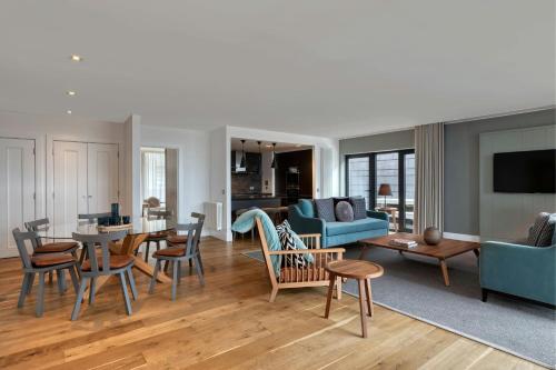 a living room with a couch and a table and chairs at Old Town Chambers, Autograph Collection in Edinburgh