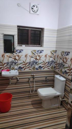 a bathroom with a toilet and a sink at Verge Hostel in Varkala