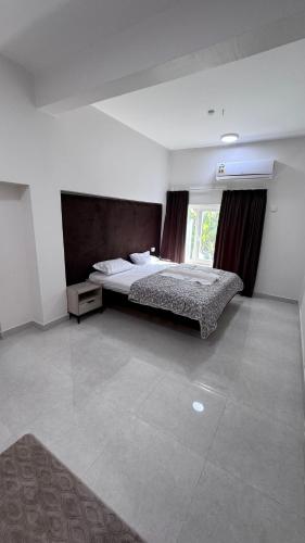 a large bedroom with a bed and a window at Nizwa heart in Nizwa
