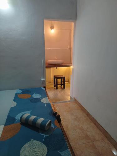 a room with a blue rug on the floor at Corner Cottage Anuradhapura - Homestay and Cooking Class in Anuradhapura
