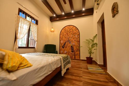 Un dormitorio con una cama en una habitación con ventana. en Lakshya - The Nature's Farm, en Karungulam