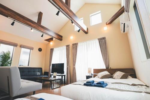 a bedroom with two beds and a living room at New! U&I Villa close Disney & Narita AP - Great View in Tokyo