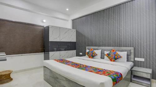 Un dormitorio con una cama grande con almohadas de colores. en Kashi Home Stay, en Jāmb