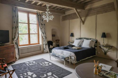 a bedroom with a bed and a large window at Maison de la Pra in Valence