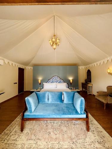 a living room with a blue couch in a tent at Surpura Bagh - A Luxury Boutique Resort in Jodhpur