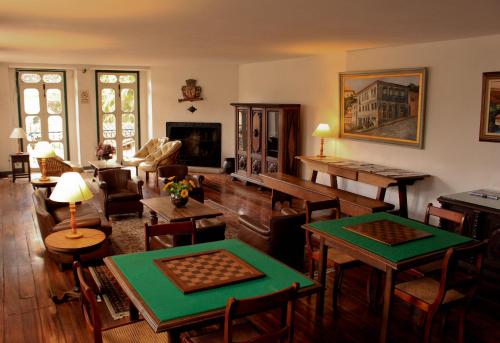 a living room with tables and chairs and a couch at Hotel Luxor in Ouro Preto