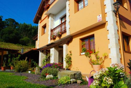 a yellow building with flowers in front of it at Posada de Ajo in Ajo