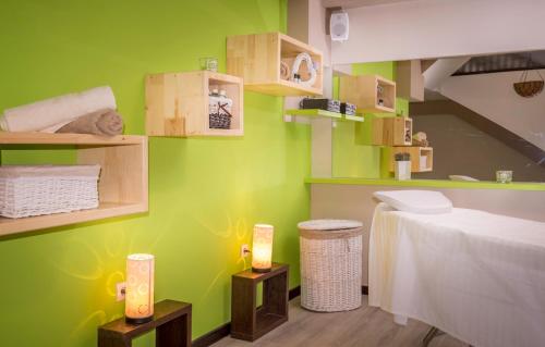 a room with green walls and shelves and a bed at Hotel Relax Sovata in Sovata
