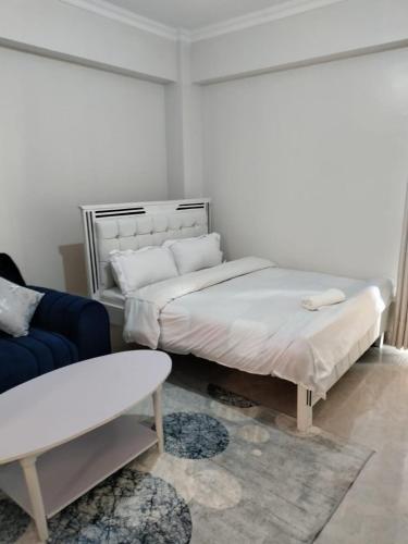 a room with two beds and a couch and a couch at Luxe Homes in Meru