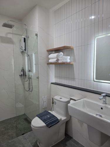 a bathroom with a shower and a toilet and a sink at Northerly นอร์ทเทอร์ลี่ in Chiang Rai