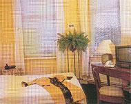 a bedroom with a bed and a desk and a window at Hotel Gasthaus Krone in Cologne