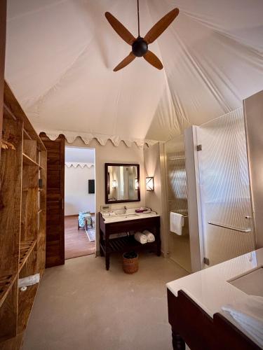 a bathroom with a ceiling fan and a mirror at Surpura Bagh - A Luxury Boutique Resort in Jodhpur