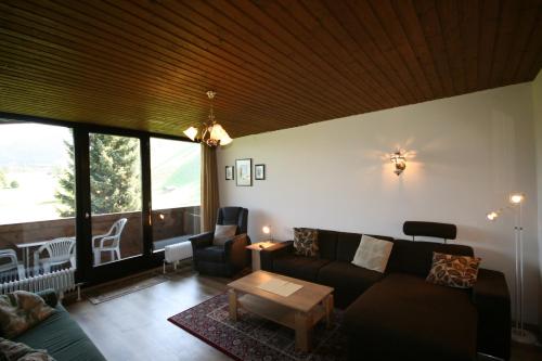a living room with a couch and a table at Appartements Domizil in Kaprun