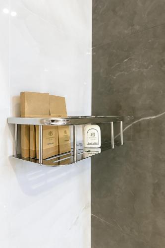 a glass shelf with boxes on it on a wall at Heaven Breeze Hotel Ella in Ella
