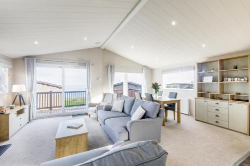 a living room with a couch and a table at Lodge 66 at Riviera Bay Coastal Retreat in Brixham