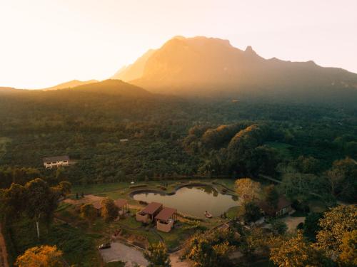 an aerial view of a park with a lake and a mountain at The Fam Cafe&Resort Chiangdao in Chiang Dao
