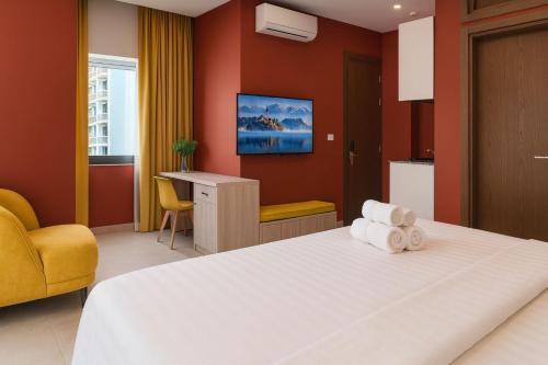 a hotel room with a bed and a desk at Shade Suites & Studios in Beirut