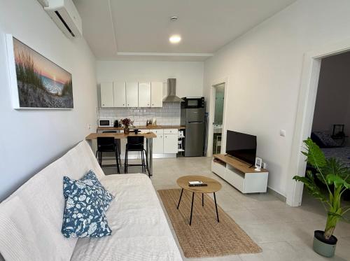 een woonkamer met een bank en een keuken bij Casa Sofia - Costa Calma Sun & Beach in Costa Calma