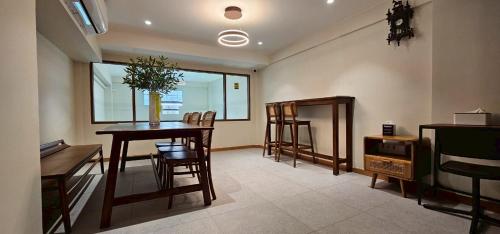 a living room with a dining room table and chairs at Loly Residence in Bangkok