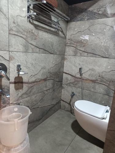 a bathroom with a toilet and a sink at DVR GRAND-AC Rooms in Visakhapatnam