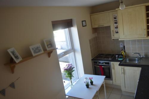 a kitchen with a table and a sink and a window at Super Central Dublin Apartments in Dublin