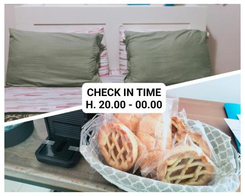 a basket of bread on a table next to a bed at La Perla B & B in Ciampino
