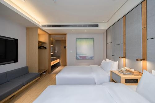 Ένα ή περισσότερα κρεβάτια σε δωμάτιο στο JI Hotel Nanjing Ming Palace