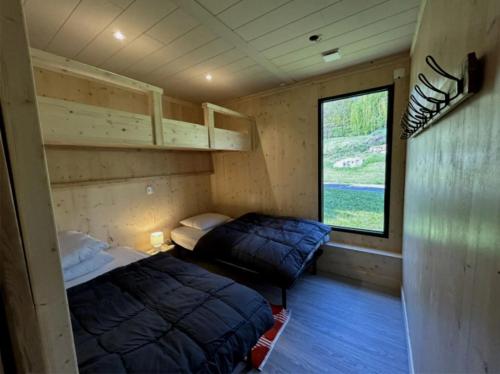 En eller flere senge i et værelse på Camping 3 étoiles - Piscine - ccbca0i