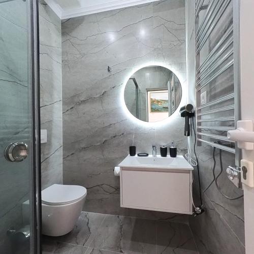 un baño con lavabo y espejo en Mateo Rooms, en Himare