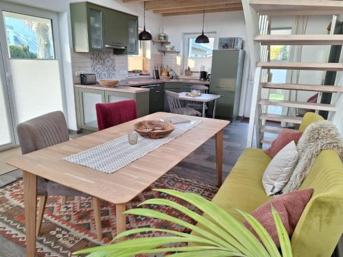 a living room with a wooden table and a kitchen at Haus Theda in Fockbek