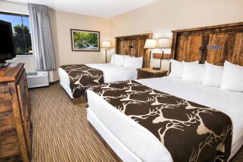 Una habitación de hotel con dos camas y un televisor de pantalla plana. en Days Inn Springfield South, en Springfield