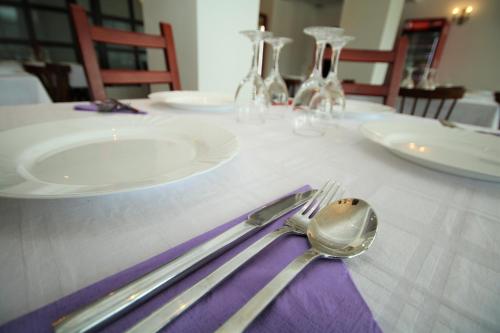 a table with a purple napkin and fork and spoon at Mai Danube in Eşelniţa