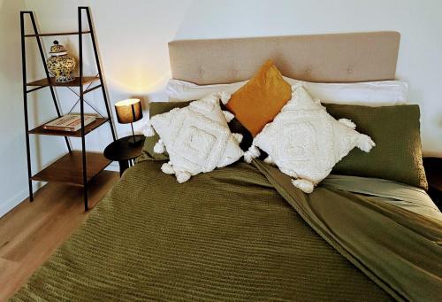 a bed with pillows on it in a room at Honeycomb Hill of Yarra Valley in Steels Creek