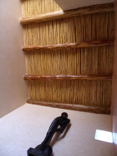 a black object sitting on the floor in front of a shelf at Dar Rio Oro in Dakhla
