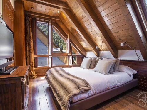 a bedroom with a bed and a large window at ADELAIDA de Alma de Nieve in Baqueira-Beret