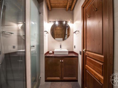 a bathroom with a sink and a shower and a mirror at ADELAIDA de Alma de Nieve in Baqueira-Beret