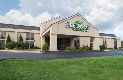 a greenasy office building with a sign on it at Greenstay Hotel & Suites Central in Springfield