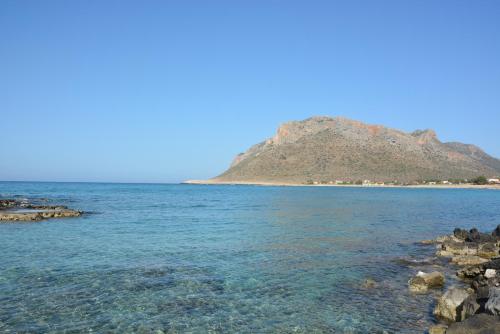 a view of the beach with a mountain in the background at Blue Beach Villas Apartments in Stavros