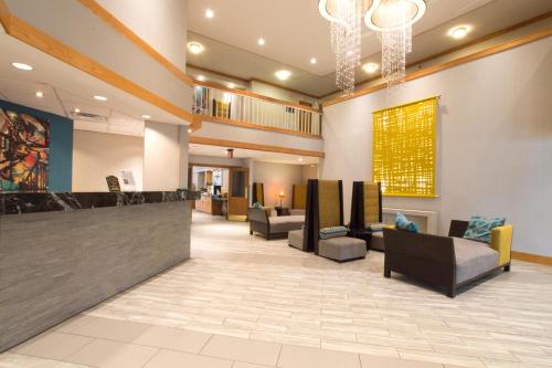 a lobby of a hospital with couches and a bar at Greenstay Hotel & Suites Central in Springfield