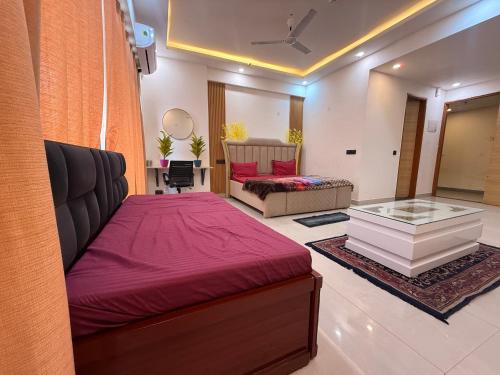 a living room with a bed and a couch at Your own bnb in Ghaziabad