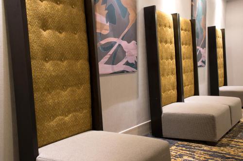 a pair of stools in a room with gold walls at Greenstay Hotel & Suites Central in Springfield