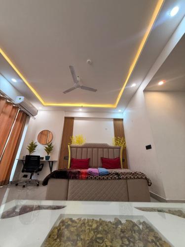 a bedroom with a bed with a ceiling fan at Your own bnb in Ghaziabad