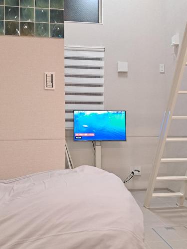 Postel nebo postele na pokoji v ubytování 専用温泉付き客室103