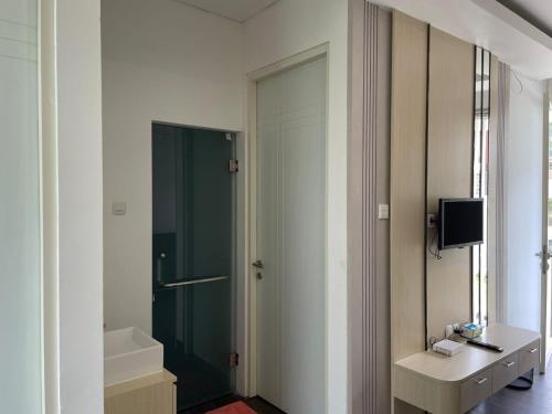 a bathroom with a shower and a sink and a mirror at Orlando Hill Villa in Ngadisari