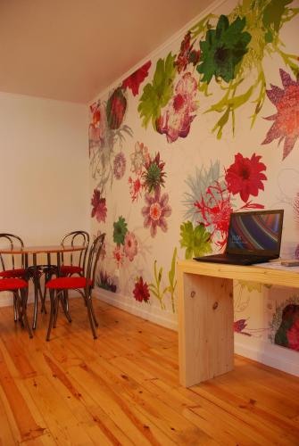 a dining room with a flower mural on the wall at Vila Maior in Sertã