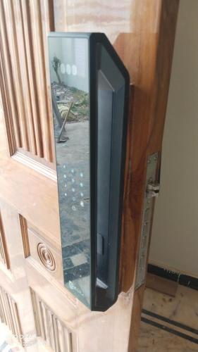 a television sitting inside of a wooden door at Prayagi in Prayagraj