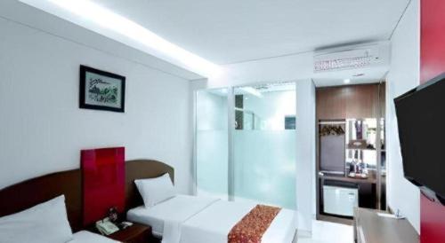 Ένα ή περισσότερα κρεβάτια σε δωμάτιο στο Kenari Asri Hotel