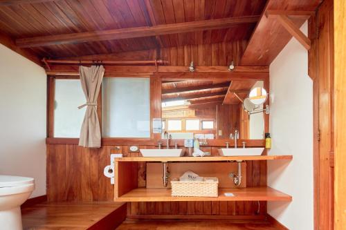 a bathroom with two sinks and a toilet at Blu Galapagos Sustainable Waterfront Lodge in Puerto Ayora