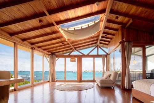 a living room with a view of the ocean at Blu Galapagos Sustainable Waterfront Lodge in Puerto Ayora