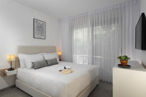 Ένα ή περισσότερα κρεβάτια σε δωμάτιο στο Herzl Boutique Hotel & Apartments by Domus